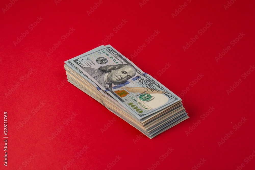 Pack of hundred-dollar bills on re background Pack of hundred-dollar bills on re background