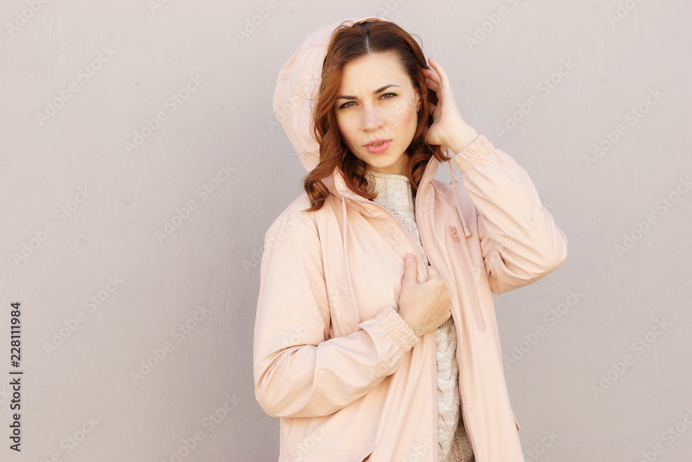 portrait of a beautiful young red-haired girl in cozy clothes on the street portrait of a beautiful young red-haired girl in cozy clothes on the street