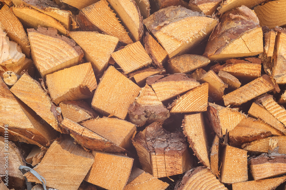 Fototapeta premium Firewood stacked. Chipped firewood. Background