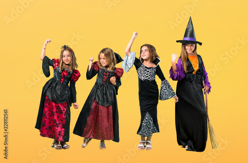 Set of Little girl dressed as a vampire for halloween holidays celebrating a victory on orange background