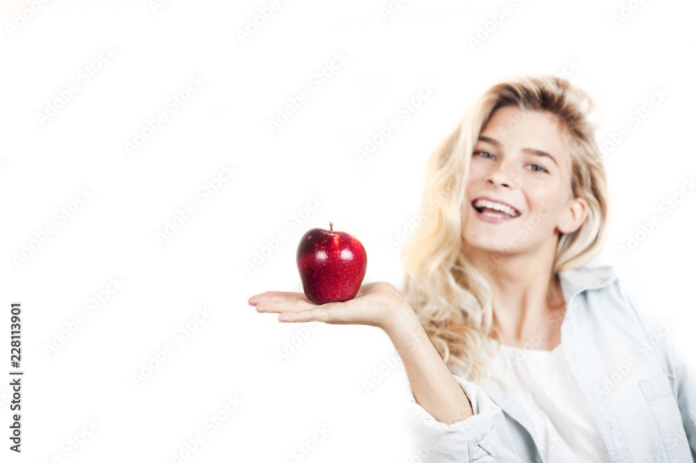 Very beautiful young bright girl holding a red apple in her hands on a white background Very beautiful young bright girl holding a red apple in her hands on a white background