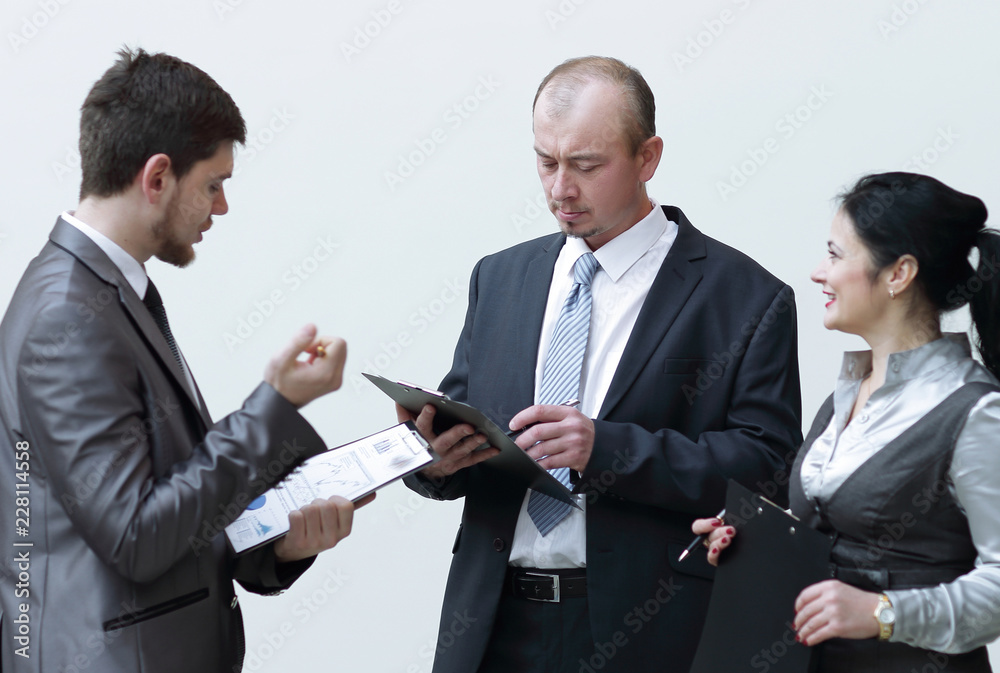 group of business people discussing financial documents. group of business people discussing financial documents.