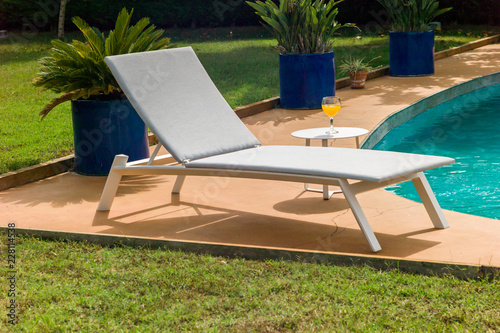 Sun lounger near pool.
