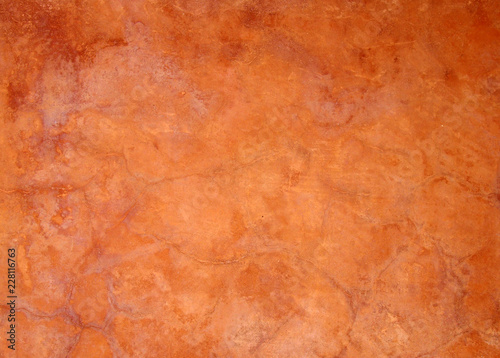 old bright orange brown painted faded stained cracked rough plaster wall background