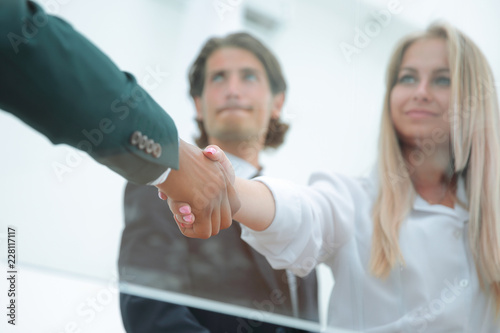 young business woman shaking hands with the investor.