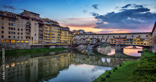 Evening view of the famous bridge Ponte Vecchio on the river Arno in Florence, Italy. © Tryfonov