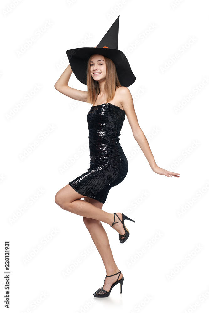 Full length playful Halloween witch isolated on white background Full length playful Halloween witch isolated on white background