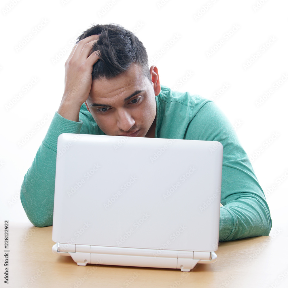 young man staring at laptop, isolated on white young man staring at laptop, isolated on white
