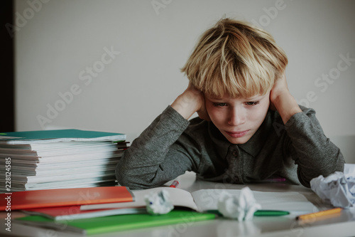 little boy tired stressed of doing homework, bored, exhausted