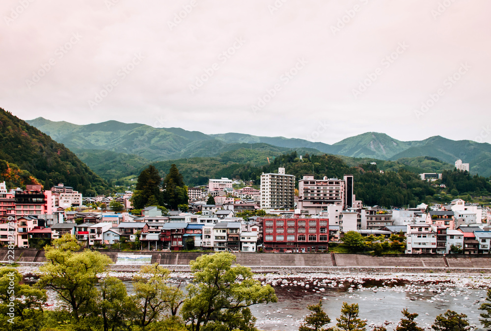 Natural river and mountain of Gero onsen resort town in Gifu, Japan - autumn season