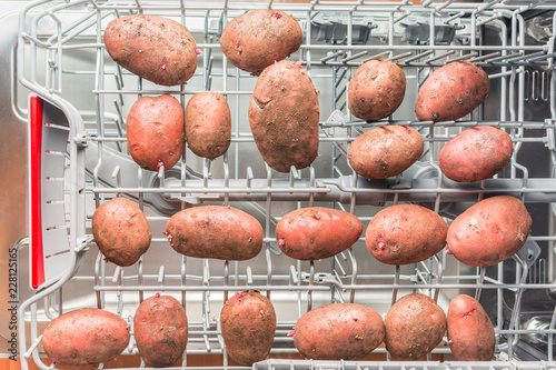 Dirty potatoes lie in the dishwasher