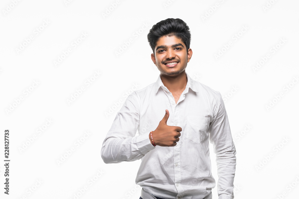 Happy young Indian businessman showing thumbs up sign isolated over white background Happy young Indian businessman showing thumbs up sign isolated over white background