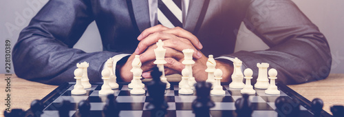 businessman playing chess board