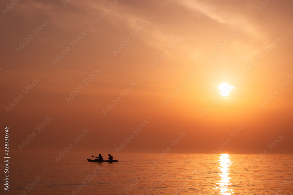 Golden Horizon: Silhouetted Kayakers at Exotic Sunset Golden Horizon: Silhouetted Kayakers at Exotic Sunset