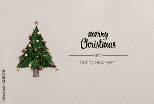 Merry Christmas and happy new year greetings in vertical top view cardboard with natural eco decorated christmas tree pine.Ecology concept.Xmas winter holiday season social media card background 