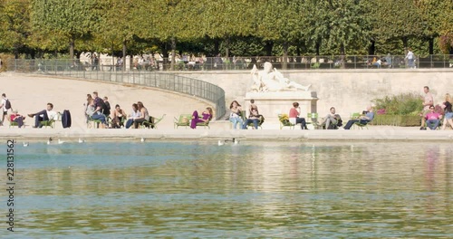 People gathering near the Seine river in Paris during summer days