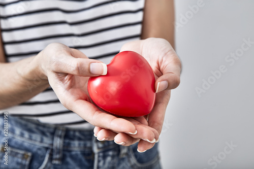Fototapeta Naklejka Na Ścianę i Meble -  Red heart shape in the hands