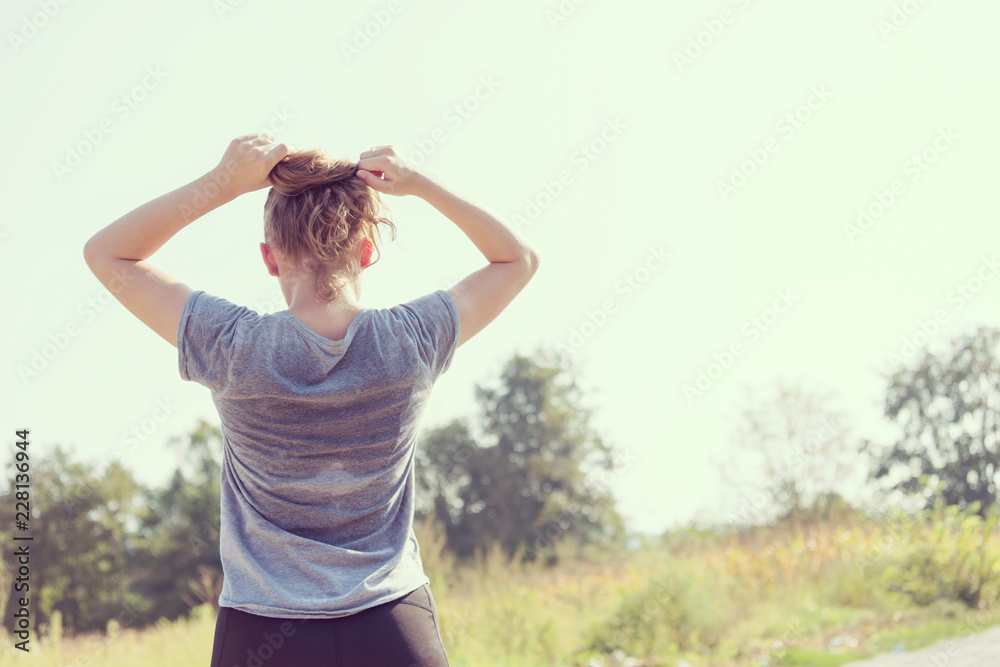 woman jogging along a country road