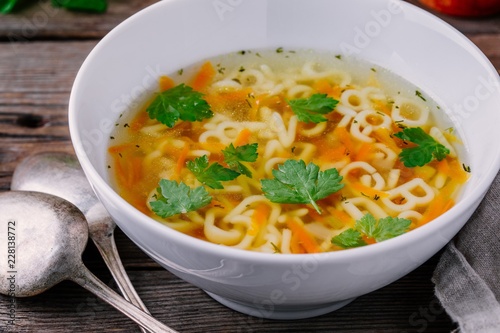 Homemade Chicken and Alphabet Soup with carrots and parsley in bowl
