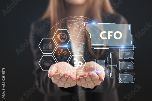 The concept of business, technology, the Internet and the network. A young entrepreneur working on a virtual screen of the future and sees the inscription: CFO