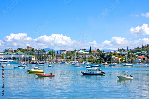 Boats at anchor & city in the background of Noumea harbour, New Caledonia.