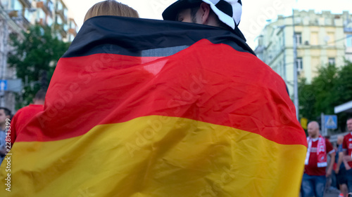 Germany football team supporters covered with flag walking in street  patriots