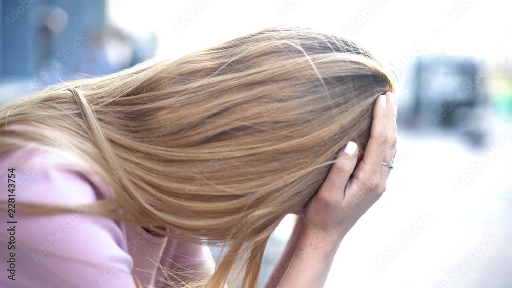 Fototapeta premium Teenage girl crying in city street, suffering depression, break-up problems