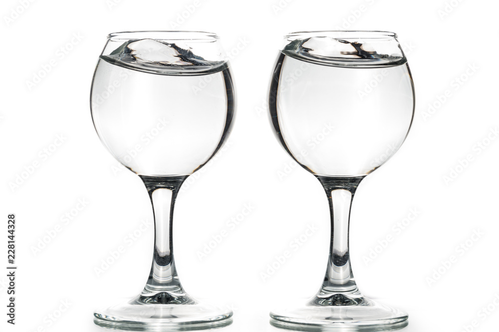 Two round glasses empty or full with waves of liquid on a white background Two round glasses empty or full with waves of liquid on a white background