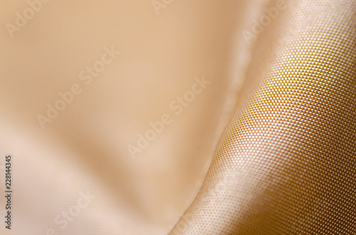 Fabric material textile texture golden seam jacket lining macro blur background