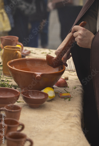 A man is preparing queimada (traditional Galician hot drink made with flamed "orujo", sugar and lemon)
