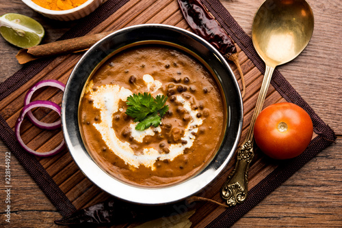 Dal makhani / makhni is a popular dish from India. Made with ingredients like whole black lentil, butter and cream. Served with Naan/roti and rice photo