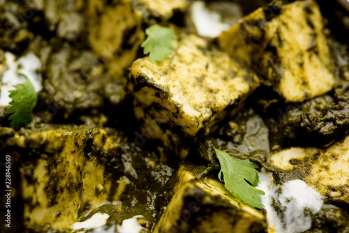 Palak Paneer Curry made up of spinach and cottage cheese served in a bowl or pan with roti or rice © Arundhati