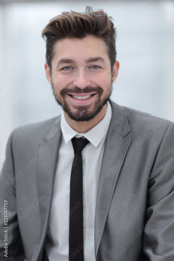 Portrait of a young businessman at the railing in the office Portrait of a young businessman at the railing in the office