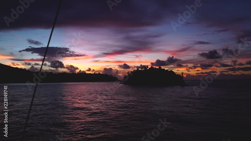 an incredible sunset in the banda sea, seen from a boat with the camera zooing out. photo