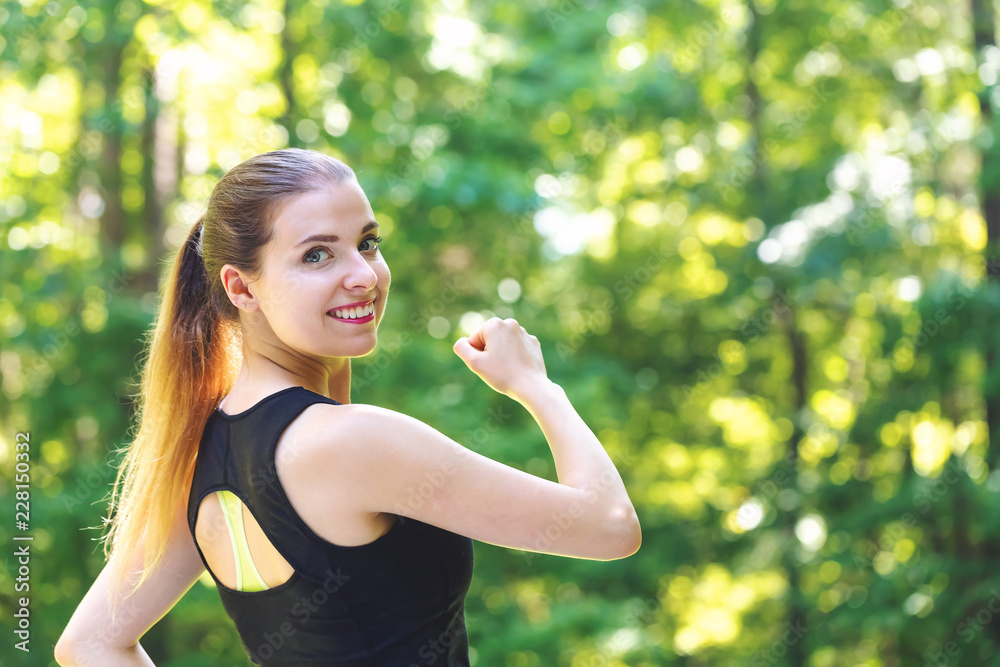 Athletic young woman jogging on a bright summer day in the forest Athletic young woman jogging on a bright summer day in the forest