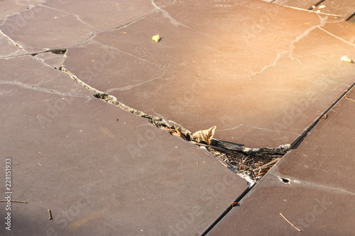 Broken brown tile floor