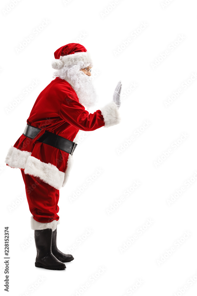 Full length profile shot of Santa Claus waving Full length profile shot of Santa Claus waving