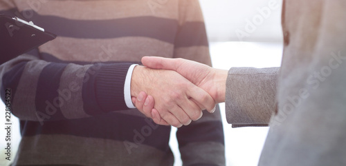 closeup of a business handshake colleagues. © ASDF