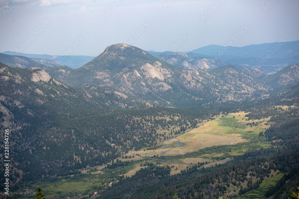 Sweeping views of Rocky Mountain park under cloudy skies as seen from the southern section of the park