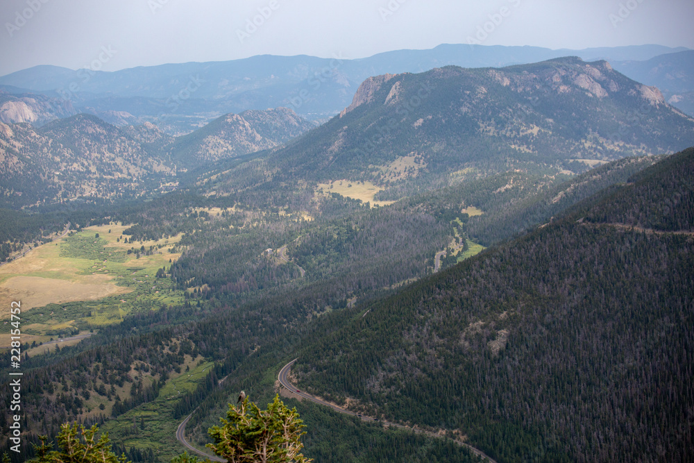 Sweeping views of Rocky Mountain park under cloudy skies as seen from the southern section of the park