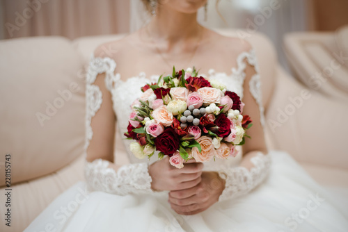 bride holds a bouquet, the bride's bouquet, wedding day, bride in a wedding dress