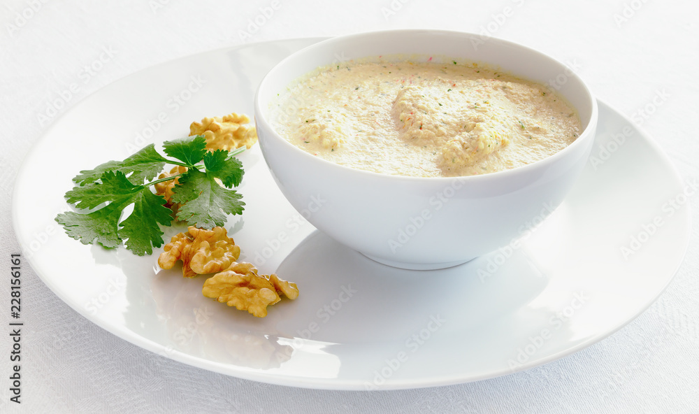 chicken in satsivi sauce decorated with cilantro and walnuts chicken in satsivi sauce decorated with cilantro and walnuts