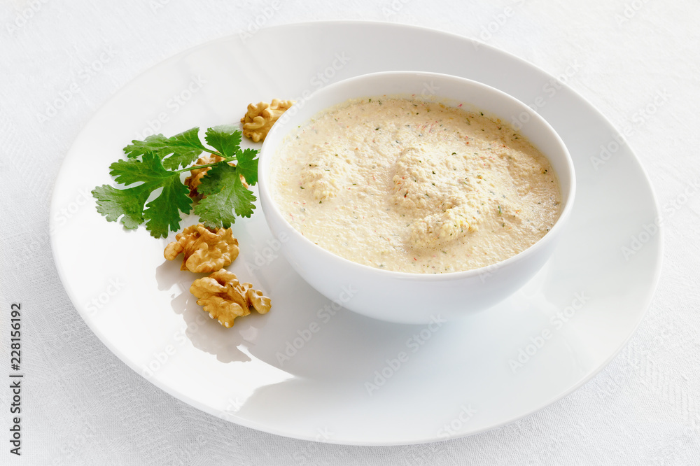 chicken in walnuts sauce decorated with cilantro and walnuts chicken in walnuts sauce decorated with cilantro and walnuts