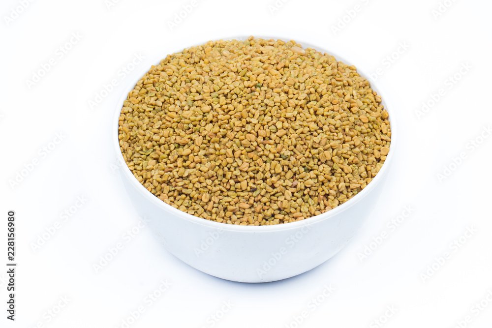 Dried fenugreek seeds isolated on white background