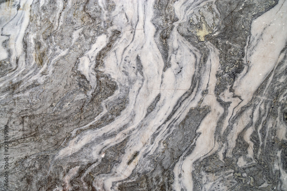 Curly pattern on marble stone for background. Natural marble texture. Marble from canyon Ruskeala. Russia. Curly pattern on marble stone for background. Natural marble texture. Marble from canyon Ruskeala. Russia.
