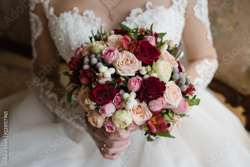 bride holds a bouquet, the bride's bouquet, wedding day, bride in a wedding dress photo