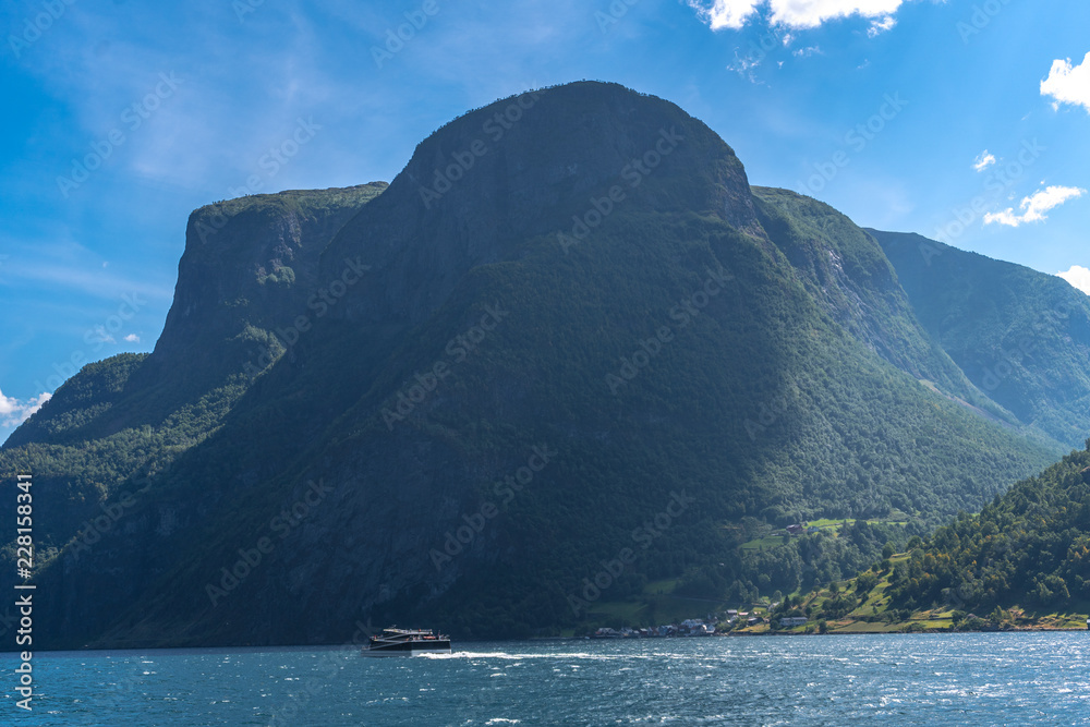 Norwegian fjord panorama, fjord cruise vessel under way. Aurlandsfjord fjord landscape from the water