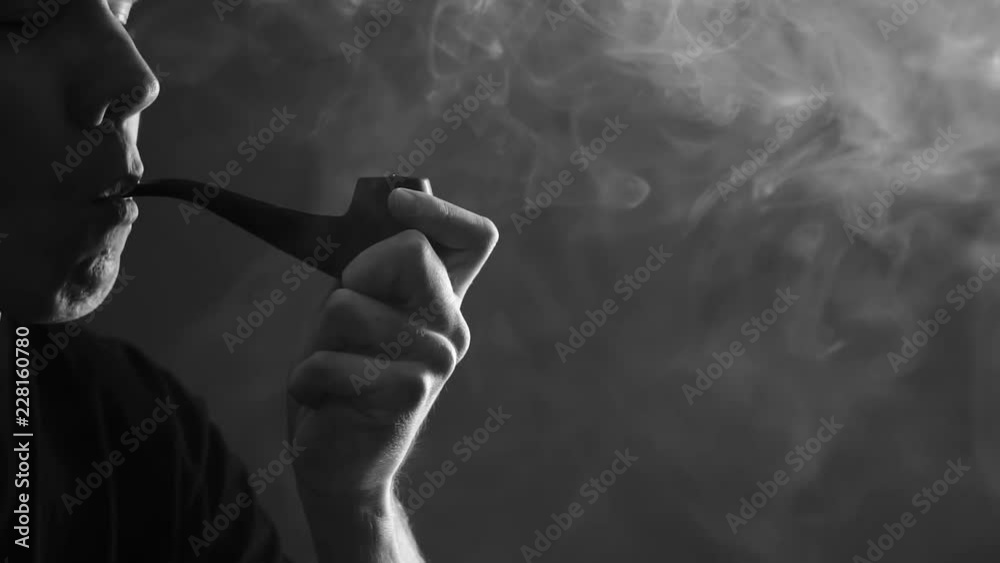 man lights Smoking pipe