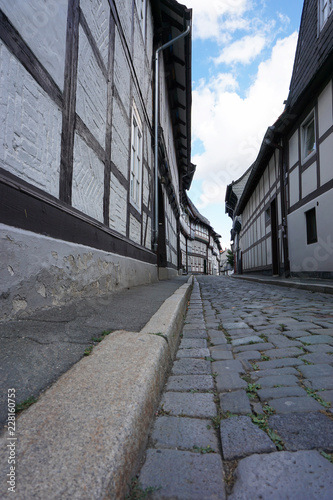 Gasse mit fachwerk und Kopfsteinpflaster in Goslar - street in the old town of goslar photo