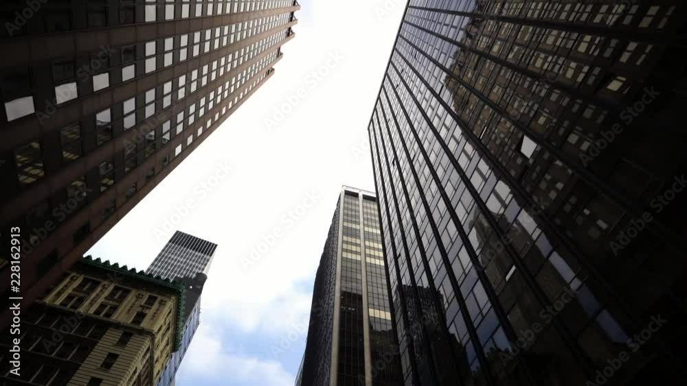 looking up drone moving shot of NYC New York City Manhattan modern skyscraper high-rises 